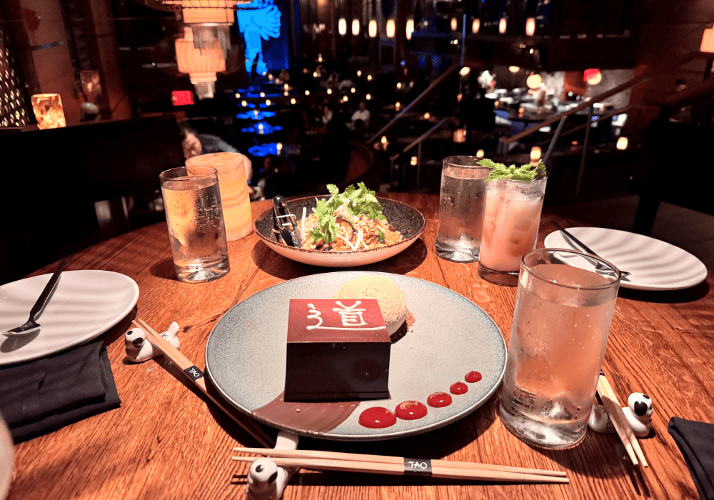 Dessert and drinks laid out on a warmly lit restaurant table.